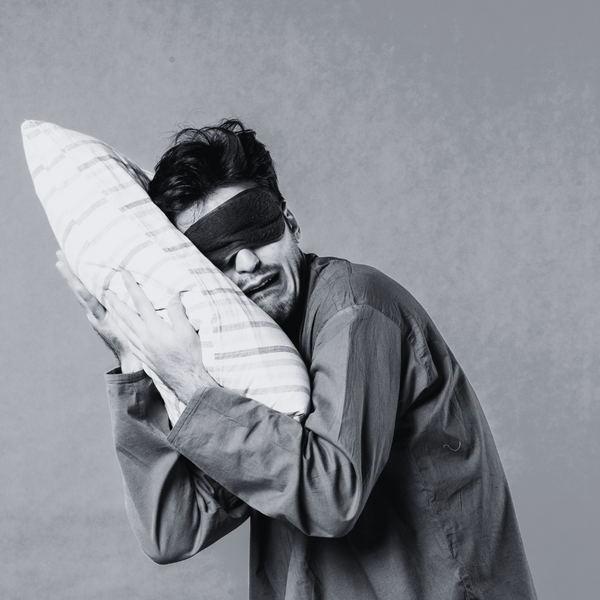 Person relaxing in bed learning to let go of sleep pressure