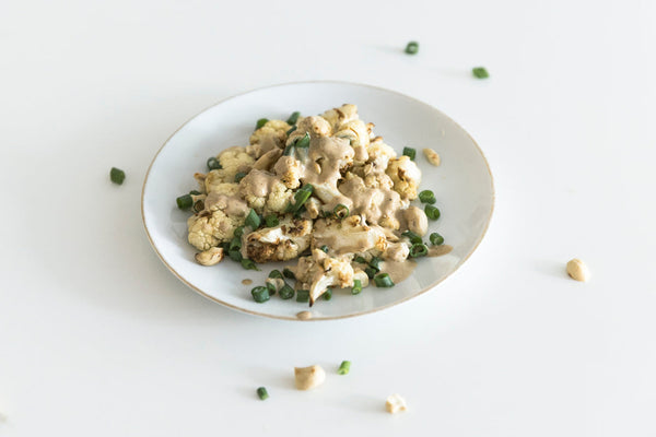 Roasted cauliflower salad with lemon tahini dressing on a plate