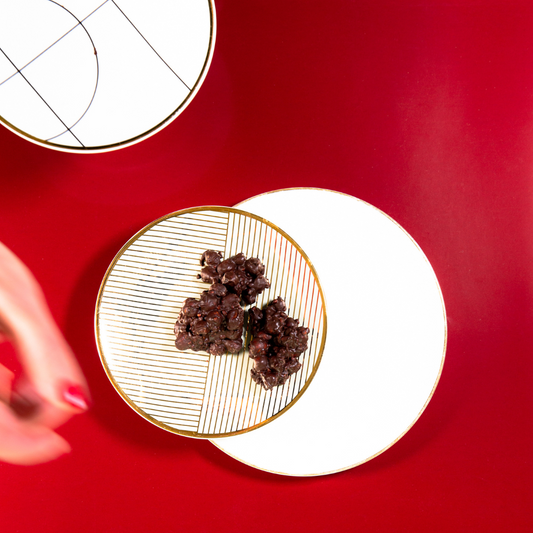 Dark chocolate almond treats with sea salt and speculaas spices on baking paper