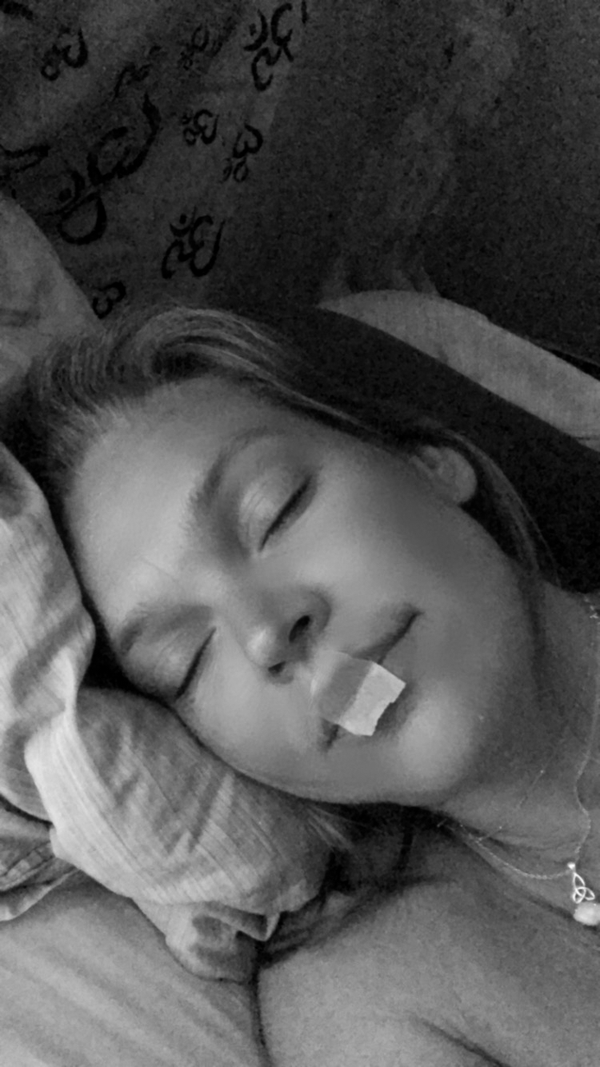 Person using mouth tape for better sleep and nasal breathing