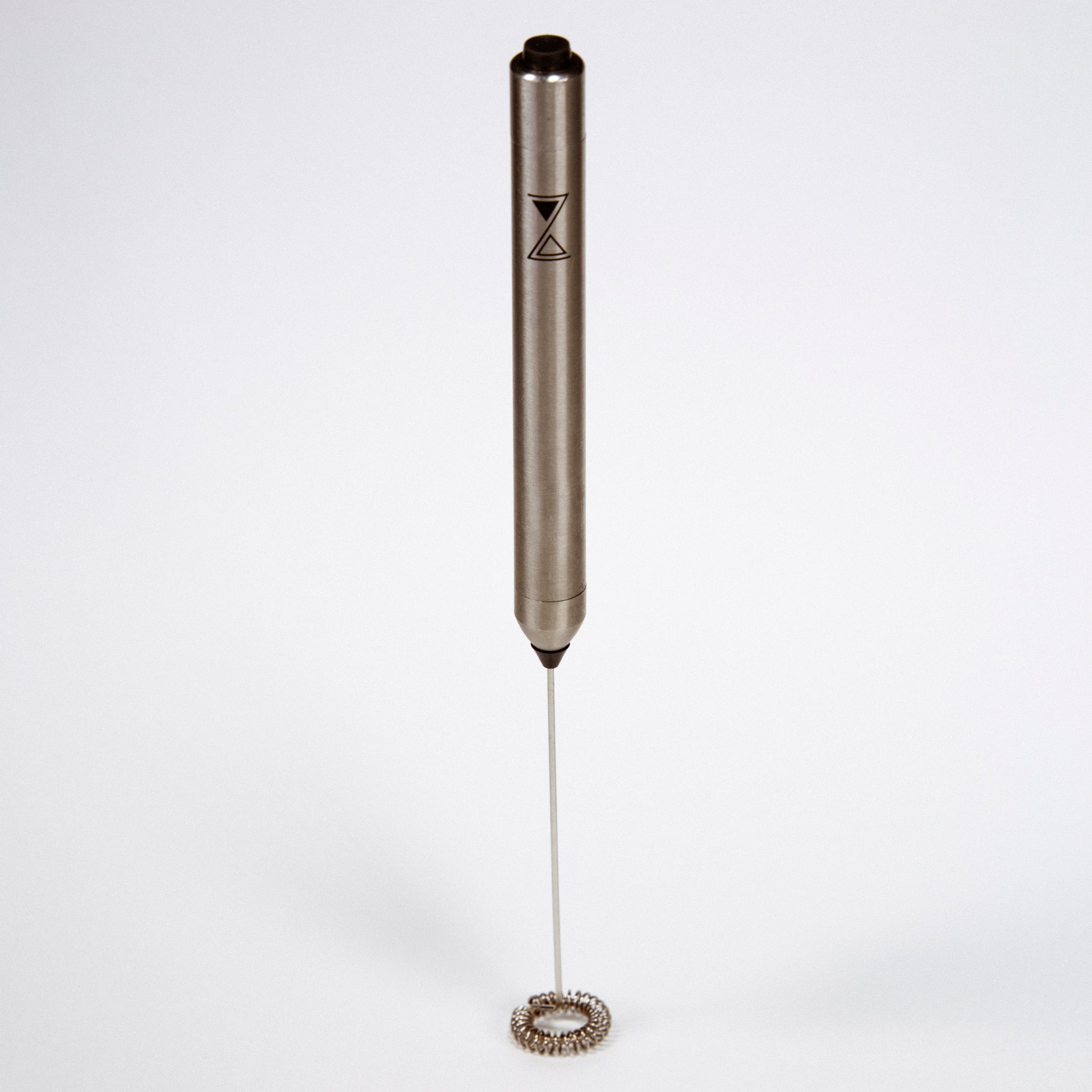 A stainless steel milk frother with a long whisk, featuring a dark-colored handle with the brand 'ZIRTUI logo' on it, against a white background.
